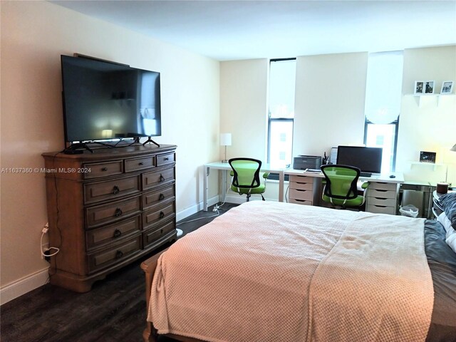 bedroom with dark hardwood / wood-style floors