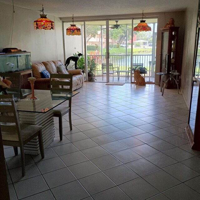 tiled living room featuring a textured ceiling