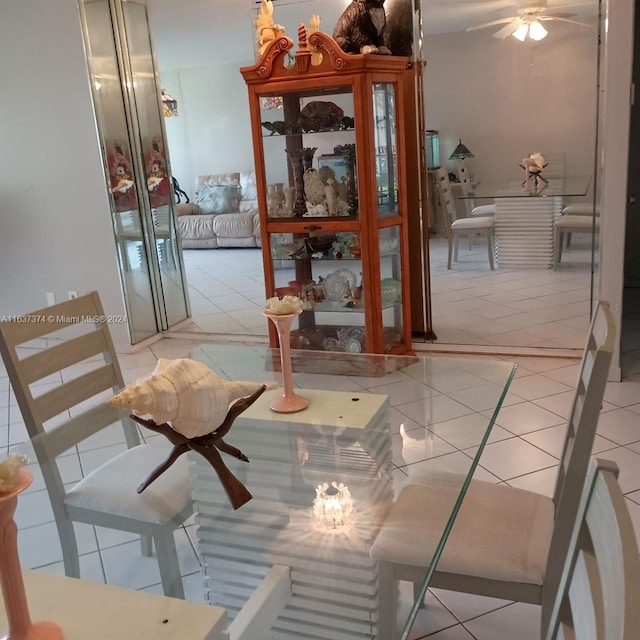 tiled dining area featuring ceiling fan