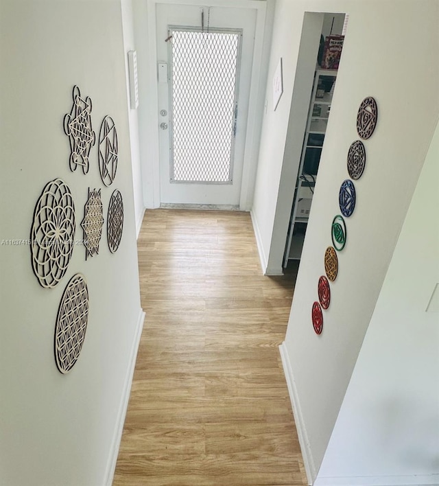 corridor with light hardwood / wood-style floors