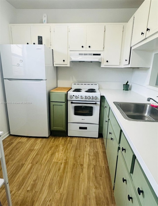 kitchen featuring green cabinets, custom exhaust hood, white appliances, and light hardwood / wood-style flooring