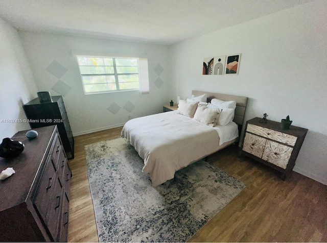 bedroom with dark wood-type flooring