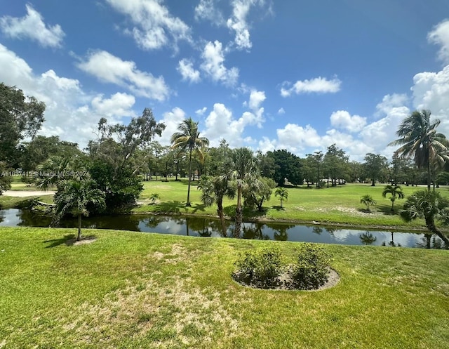 view of community with a water view and a lawn