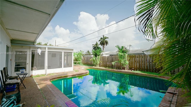 view of pool featuring a sunroom