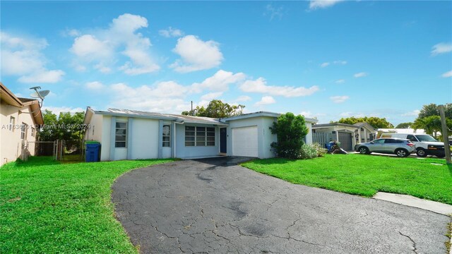 ranch-style home with a garage and a front yard