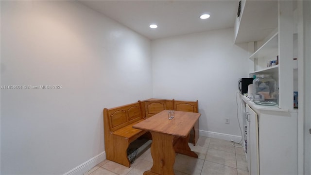 dining space featuring recessed lighting, light tile patterned flooring, and baseboards