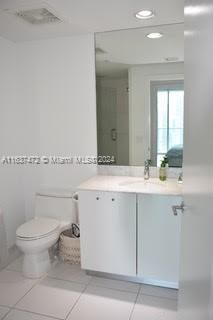 bathroom featuring tile patterned floors, vanity, and toilet