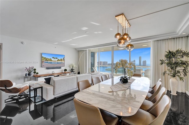 dining space with dark tile patterned flooring and floor to ceiling windows