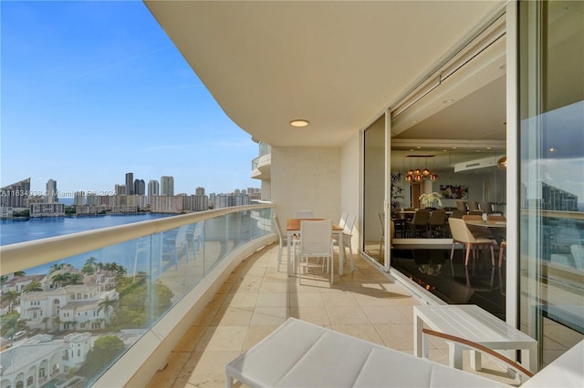 balcony featuring a water view and a city view