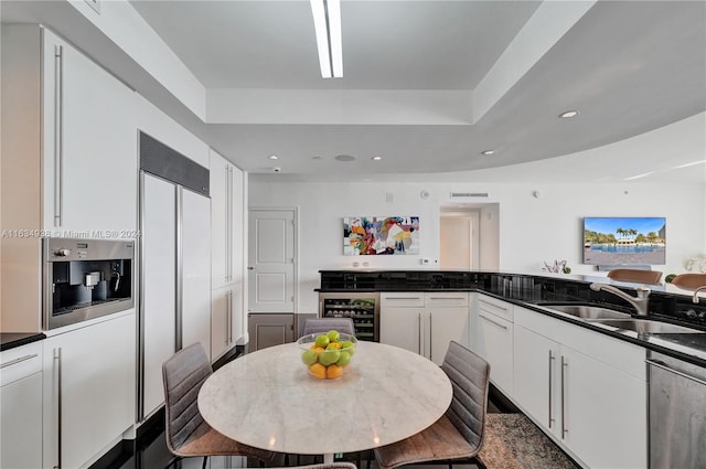 kitchen featuring white cabinets, sink, dishwasher, and wine cooler