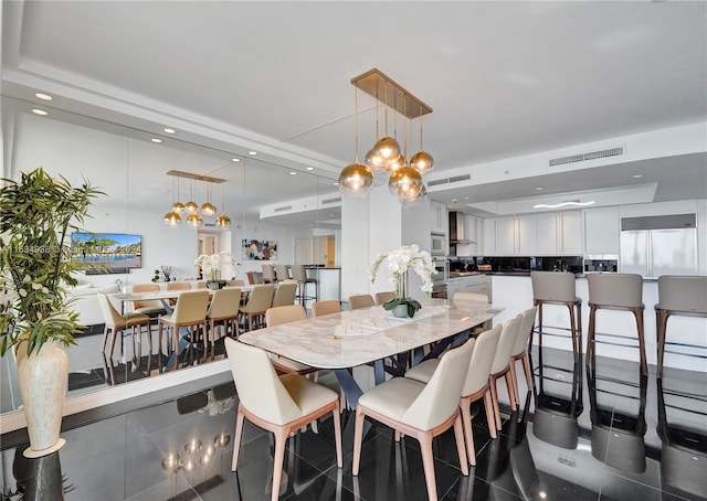 dining area with dark tile patterned flooring, visible vents, and recessed lighting