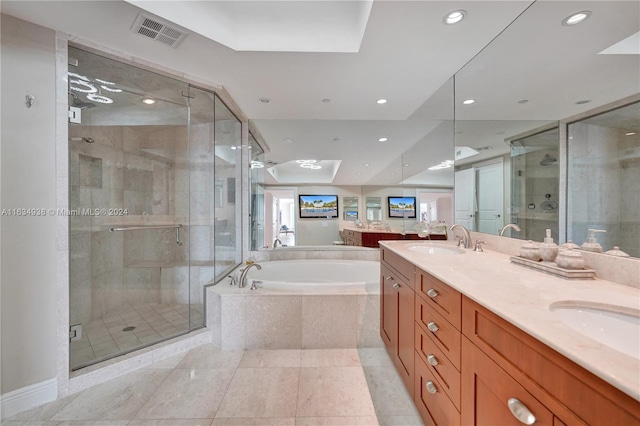 bathroom with double sink vanity, independent shower and bath, and tile patterned flooring