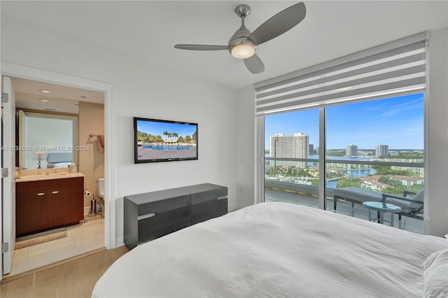 bedroom with ceiling fan, light hardwood / wood-style flooring, and connected bathroom