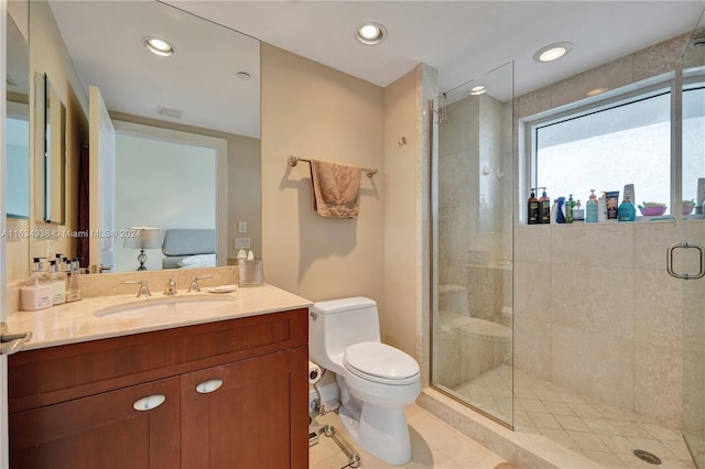 bathroom featuring a shower with shower door, vanity, tile patterned floors, and toilet