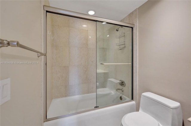 bathroom featuring toilet and enclosed tub / shower combo