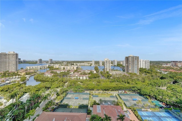 birds eye view of property with a water view and a city view