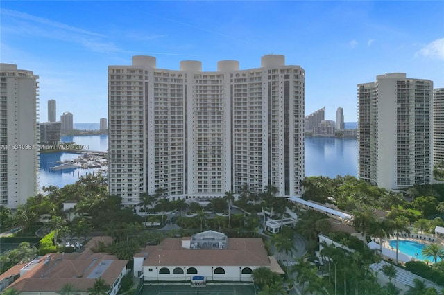 birds eye view of property featuring a water view and a city view