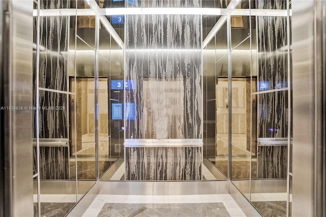 bathroom with elevator and tile patterned floors