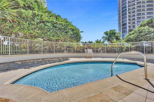 view of swimming pool featuring a swimming pool and fence