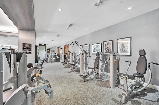 workout area featuring recessed lighting, visible vents, baseboards, and light colored carpet