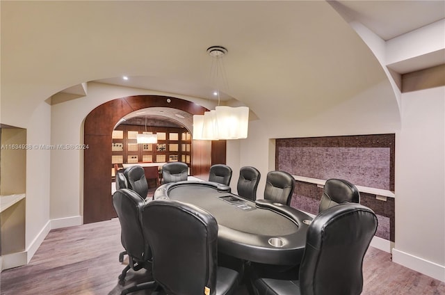 dining area with vaulted ceiling and hardwood / wood-style flooring