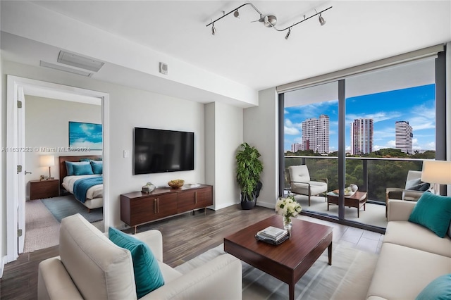 living room with hardwood / wood-style flooring and rail lighting