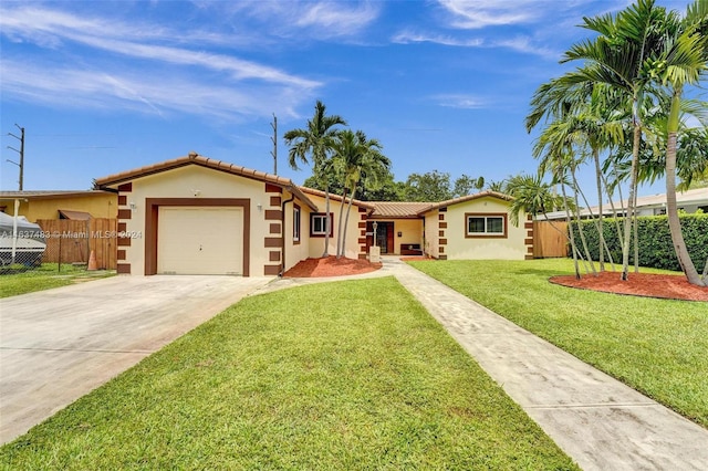 ranch-style home featuring a front lawn and a garage