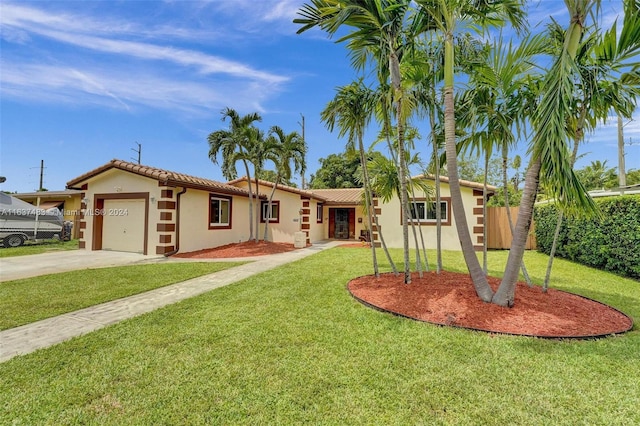 view of front of property with a front yard and a garage