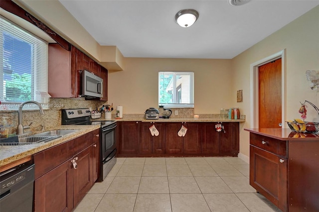 kitchen featuring decorative backsplash, light tile patterned floors, sink, and appliances with stainless steel finishes