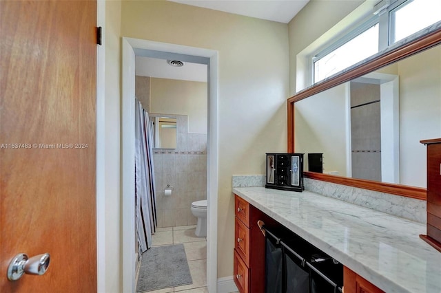 bathroom with tile patterned flooring, vanity, and toilet