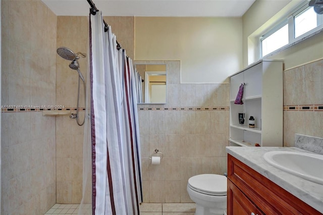 bathroom featuring vanity, tile patterned flooring, a shower with shower curtain, toilet, and tile walls