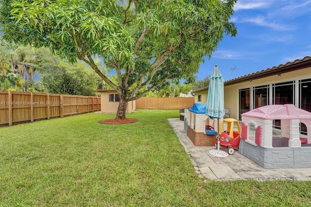 view of yard with a patio and a shed