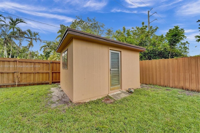 view of outbuilding featuring a yard