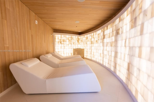 interior space with wooden walls, wooden ceiling, and tile patterned floors