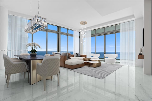 living room featuring expansive windows, light tile patterned flooring, and a water view