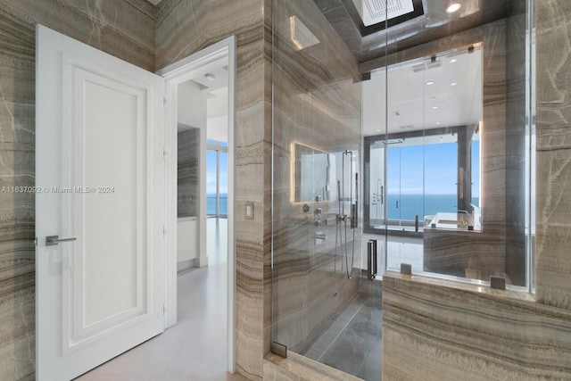 bathroom with an enclosed shower and a water view