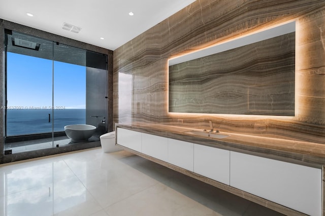 bathroom with toilet, vanity, and a water view