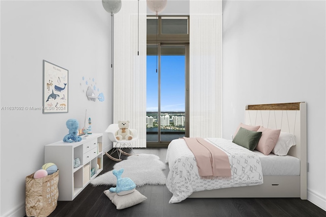 bedroom featuring dark hardwood / wood-style flooring and access to exterior