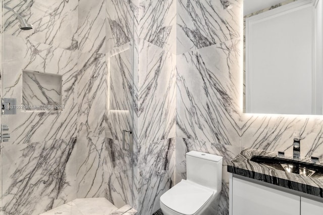 bathroom with toilet, vanity, and tile walls