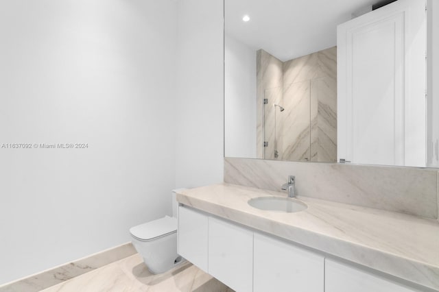 bathroom featuring toilet, vanity, and tiled shower