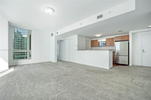 unfurnished living room featuring carpet