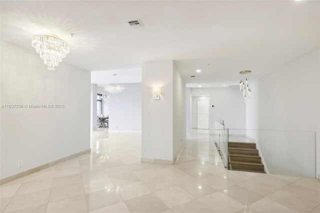 hallway with light tile patterned floors and a chandelier