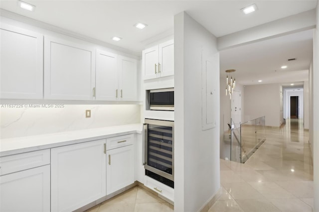 kitchen with white cabinets, light tile patterned floors, and wine cooler