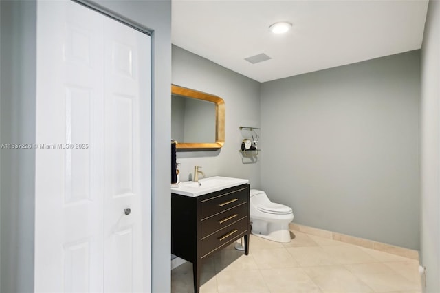 bathroom with vanity, tile patterned flooring, and toilet