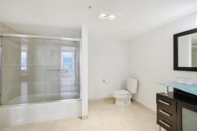 full bathroom with toilet, tile patterned flooring, enclosed tub / shower combo, and vanity