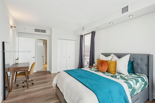 bedroom with a closet and hardwood / wood-style flooring