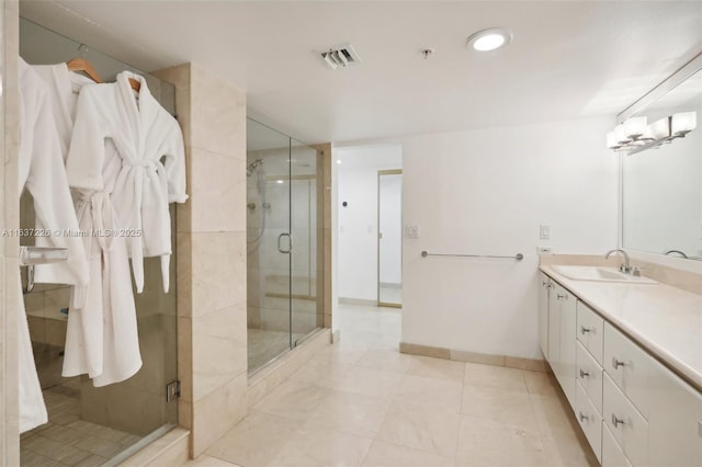 bathroom with vanity and a shower with shower door