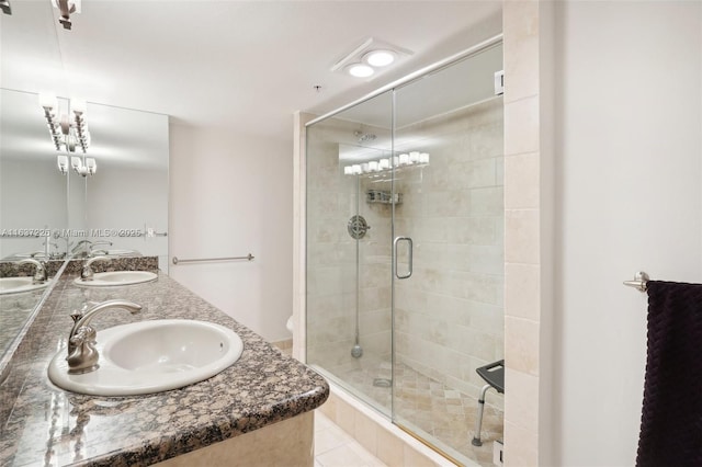 bathroom featuring vanity, walk in shower, and tile patterned flooring