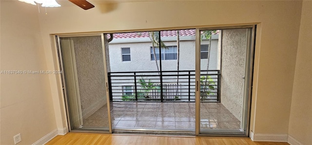 doorway featuring light hardwood / wood-style floors and ceiling fan