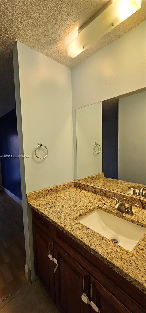 bathroom featuring vanity and a textured ceiling